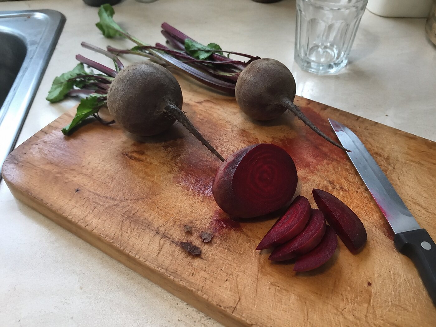 Fresh beetroot being prepared on a home kitchen cutting board